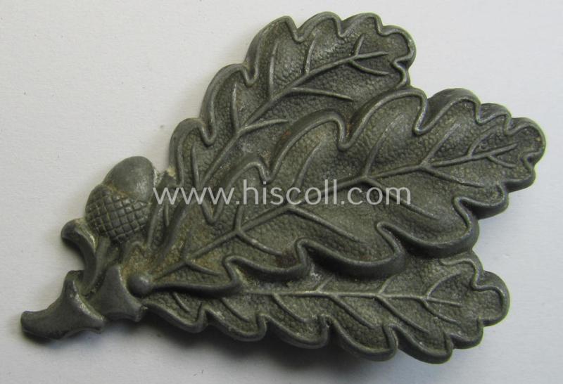 Neat - and just moderatly used and/or worn! - WH (Heeres) silver-greyish-coloured so-called: 'M43'-pattern cap-badge (ie. 'Mützenabzeichen') depicting three: 'Eichenlaub'-branches as was used by the various 'Jäger'-related, divisional staff-member