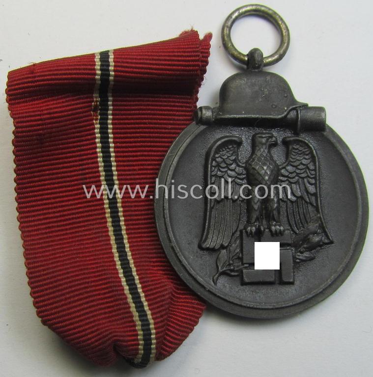 Neat medal-set: 'Winterschlacht im Osten 1941-42' being a non-maker-marked- (and/or typical 'Feinzink'-based) specimen that comes together with its (minimally confectioned) ribbon (ie. 'Bandabschnitt')