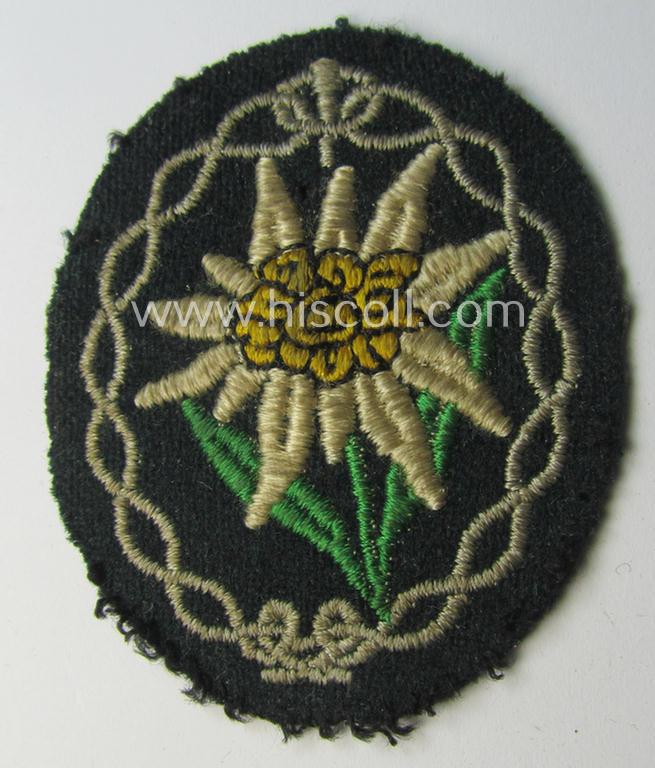 Truly used and/or tunic-removed, WH (Heeres) EM- (ie. NCO-) type, so-called: 'Edelweiss'-armpatch being a machine-embroidered example as was executed on darker-green wool as was specifically intended for usage by the: 'Gebirgsjäger-Truppen'