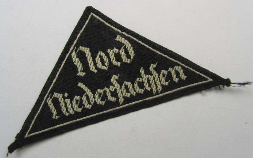 HJ/BDM ('Hitlerjugend' ie.: 'Bund Deutscher Mädel') district-triangle (ie. 'Gebietsdreieck') being an example that misses its 'RzM-etiket' and that is entitled: 'Nord Niedersachsen' and that comes in a tunic- ie. shirt-removed, condition