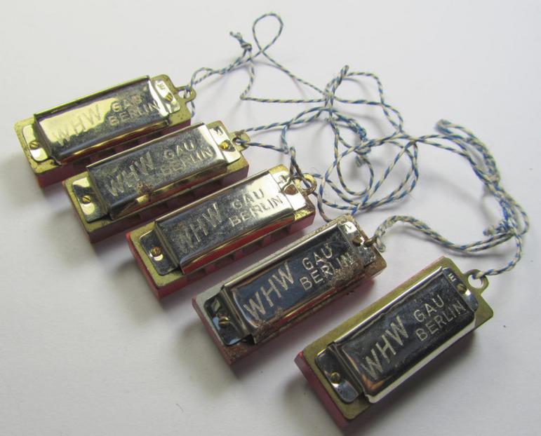 Unusally seen so-called: WHW- (ie. 'Winterhilfswerke'-) related miniature harmonica entitled: 'WHW - Gau Berlin' that comes mounted on its original cord