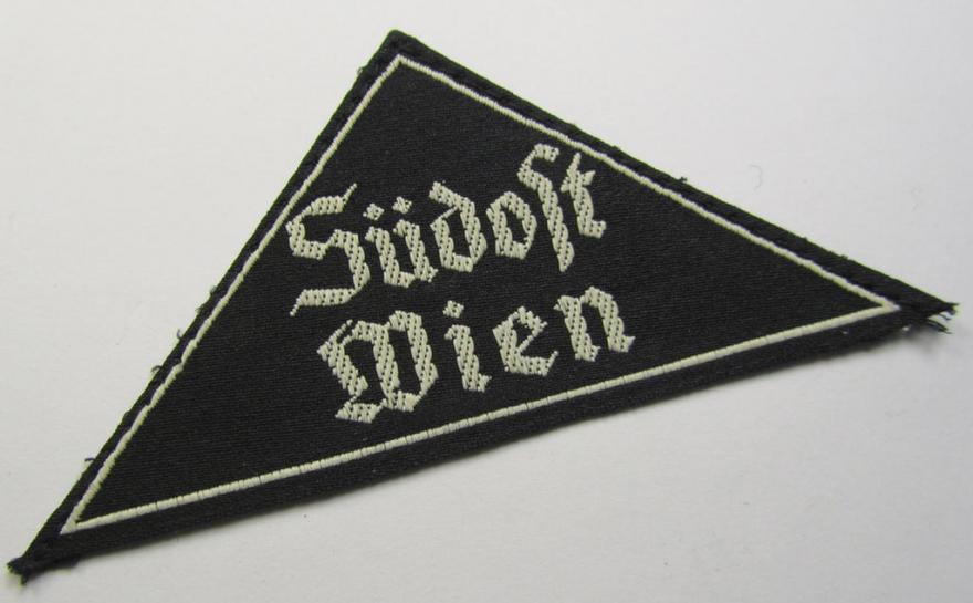 Attractive, 'HJ' ('Hitlerjugend') ie. 'BDM' (or: 'Bund Deutscher Mädel') district-triangle (ie. 'Gebietsdreieck') entitled: 'Südost Wien', that comes with its originally attached, paper-based 'RzM'-etiket