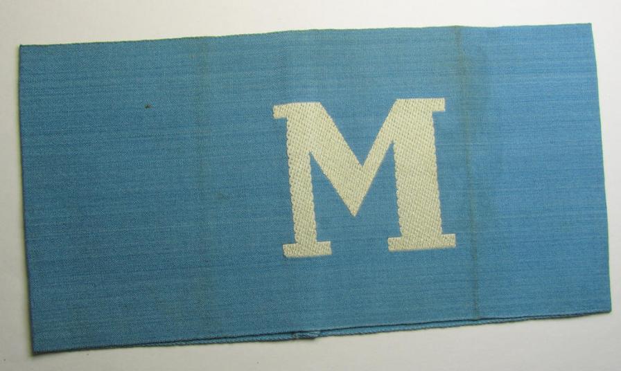 Linnen-based- and/or light-blue-coloured armband (ie. 'Armbinde') depicting an interwoven capital 'M'-character, as was presumably intended for staff-members of the German RLB (ie. 'Reichsluftschutz-Bund')