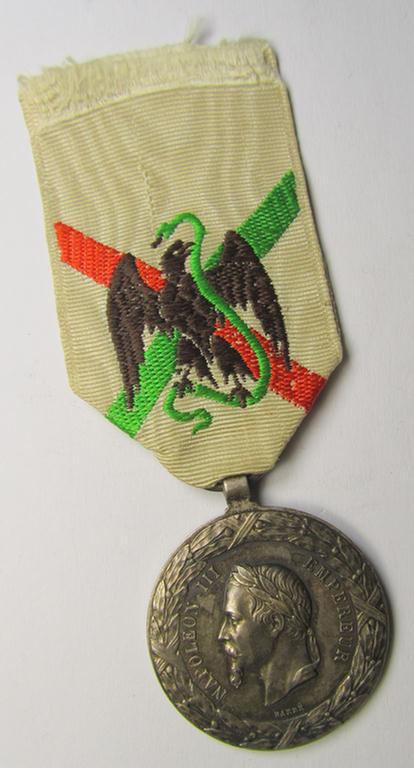 Attractive French, 'Second Empire-period', so-called: 'Expedition to Mexico'-campaign-medal (ie. 'Médaille Commémorative de l'Expédition du Mexique') that comes mounted on its period-ribbon as issued