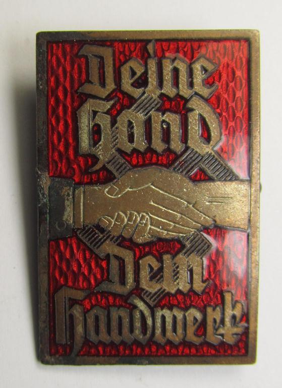 Bright-red enamelled, N.S.D.A.P.- (ie. 'DAF'-) related day-badge (ie. 'tinnie') as was issued to commemorate a specific-gathering ie. rally entitled: 'Deine Hand - Dem Handwerk'