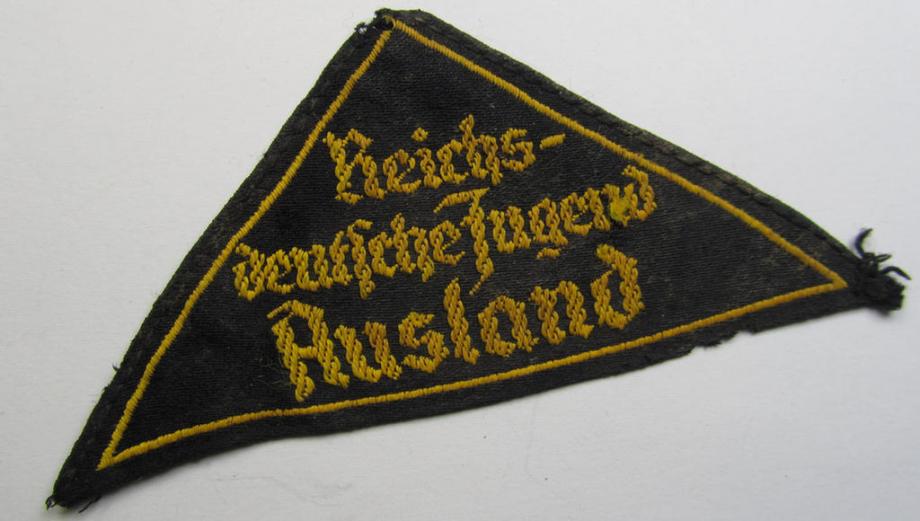 Superb - and extremely rarely encountered! - 'HJ' ('Hitlerjugend') district-triangle (ie. 'Gebietsdreieck') entitled: 'Reichs-deutsche Jugend Ausland' (being a truly worn- ie. used specimen that misses its 'RzM'-etiket)