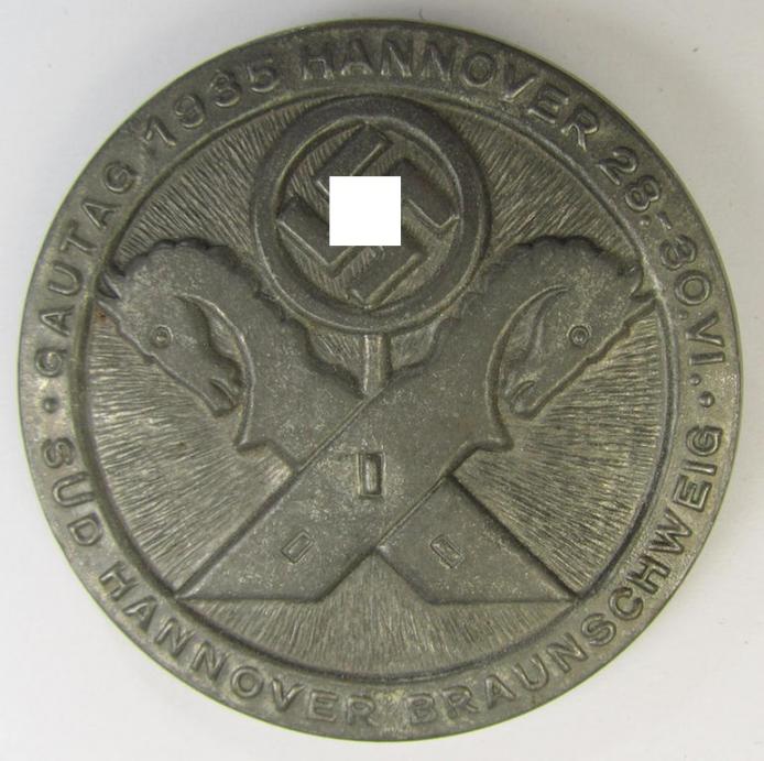 Detailed and pronounced, silverish-grey-coloured, N.S.D.A.P.-related day-badge (ie. 'tinnie' or: 'Veranstaltungsabzeichen') as was issued to commemorate the: 'Gautag 1935 - Hannover - 28.-30-1935 - Süd-Hannover-Braunschweig'