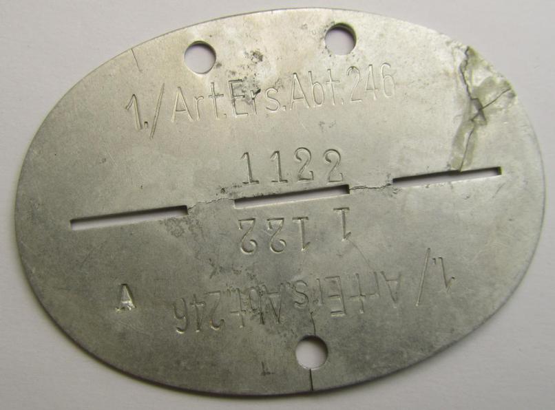 Aluminium-based, WH (Heeres) ie. 'Artillerie'-related ID-disc (ie. 'Erkennungsmarke') bearing the stamped unit-designation that reads: '1./Art.Ers.Abt. 246'