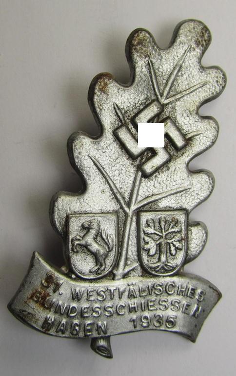 Commemorative, silver-toned- (and/or tin-based) shooting-contest (ie. N.S.D.A.P.-related) day-badge depicting a so-called: 'Eichenlaubblatt', swastika and text: '31. Westfälisches Bundesschiessen - Hagen - 1935'