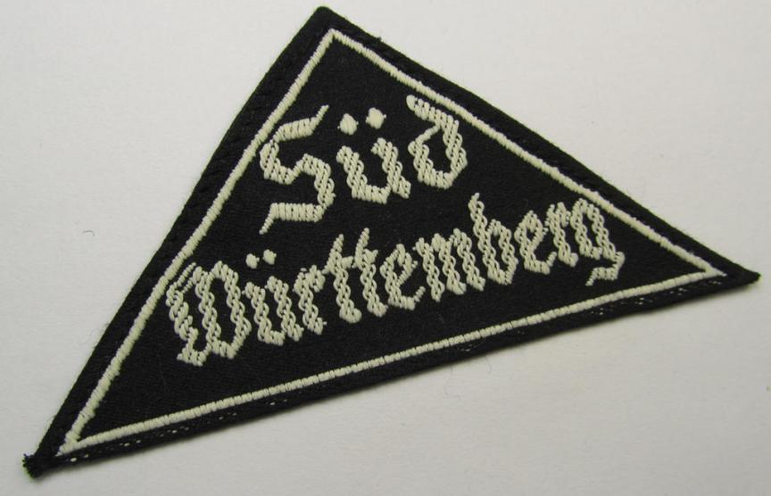 Attractive, 'HJ' ('Hitlerjugend') ie. 'BDM' ('Bund Deutscher Mädel'-) district-triangle (ie. 'Gebietsdreieck') entitled: 'Süd Württemberg' (being a never worn example that still retains its period-attached 'RzM'-etiket)