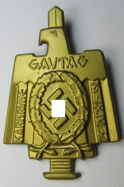 Commemorative, tin-based- and/or: bright golden-toned (I deem) N.S.D.A.P.-related 'tinnie' depicting an eagle-device resting on an upward-positioned sword and that is entitled: 'Gautag - Karlsruhe - 16.18. IV 1937'