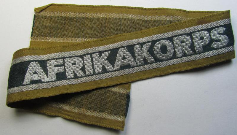 Superb, 'BeVo'-like cuff-title (ie. 'Ärmelstreifen') entitled: 'Afrikakorps' being a with certainty issued and worn example that comes in an overall nice- (ie. minimally shortened- and presumably once tunic-attached-), condition