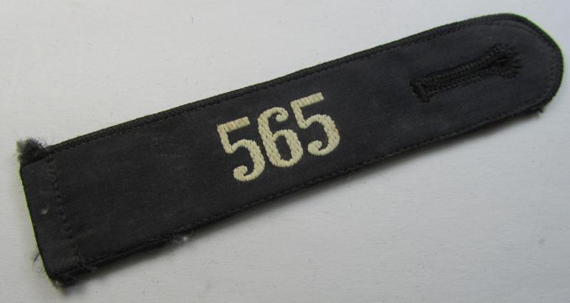 Neat - and naturally single! - black-piped, so-called: 'DJ- o. Deutsches Jungvolk' shoulderstrap as was intended for usage by a: 'DJ-Mitglied' who served within the: 'Bann 565' (565 = 'Spittal') and that comes with its 'RzM'-etiket