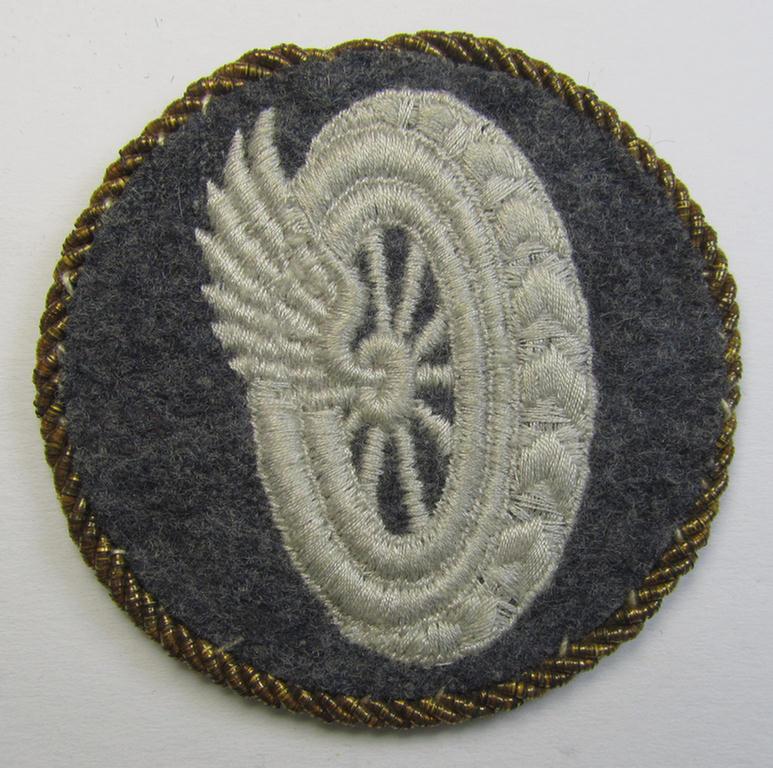 Attractive - albeit clearly used! - example of a WH (Luftwaffe) machine-embroidered, trade- ie. special-career-patch (ie. 'Tätigkeitsabzeichen') having a golden-coloured 'Goldkordel' attached as was intended for a: 'Schirrmeister o. Geräteverwalter'