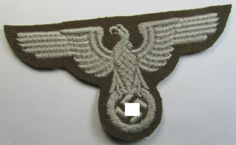 Attractive, machine-embroidered arm-eagle (ie. 'Ärmeladler') as was specifically intended for usage on the brownish-green-coloured tunics of officials of the: 'Reichsministerium für besetzte Ostgebiete' (ie. 'R.M.b.O.')