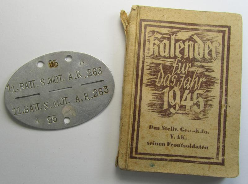 Interesting, aluminium-based WH (Heeres) ie. 'mot. Artillerie'-related ID-disc bearing the clearly stamped unit-designation: '11.Batt.S.Mot.A.R. 263' and that comes together with its 1945-dated agenda (ie. 'Kalender') as stored for decades