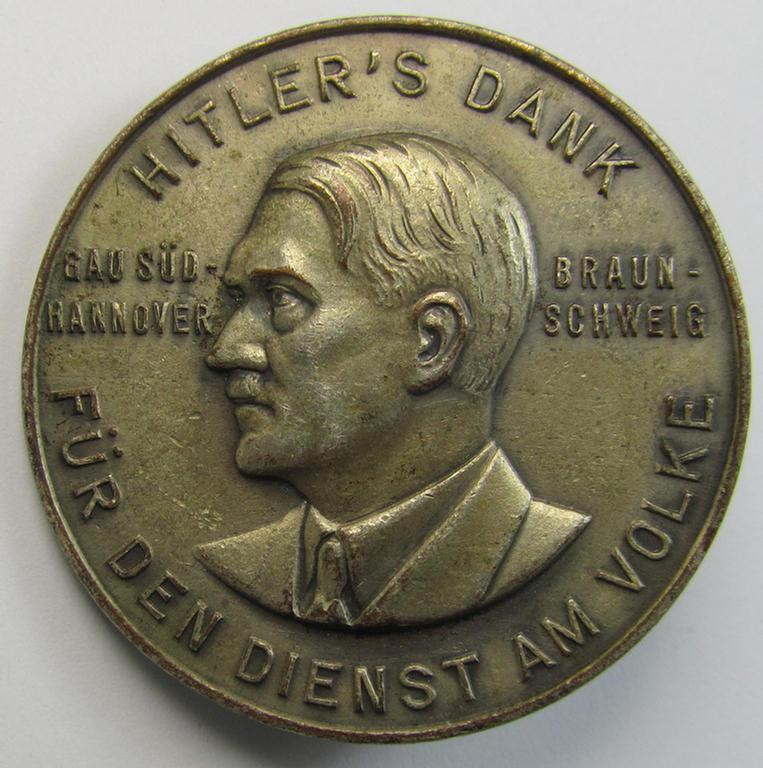 Commemorative, silvered 'Buntmetall'-based N.S.D.A.P.- (ie. WHW-) related 'tinnie' being a maker- (ie. 'Paulmann u. Crone'-) marked example depicting A.Hitler and text: 'Hitlers' Dank für den Dienst am Volke - Gau Süd-Hannover - Braunschweig'