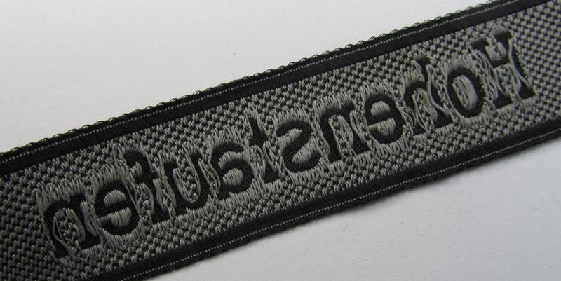 Hiscoll Military Antiques  Superb, 1943/44 pattern Waffen-SS cuff-title,  depicting the machine-woven 'Latin'-script text in silver-grey linnen as  was intended for a member of the: '9. SS-Panzer-Division' “Hohenstaufen”