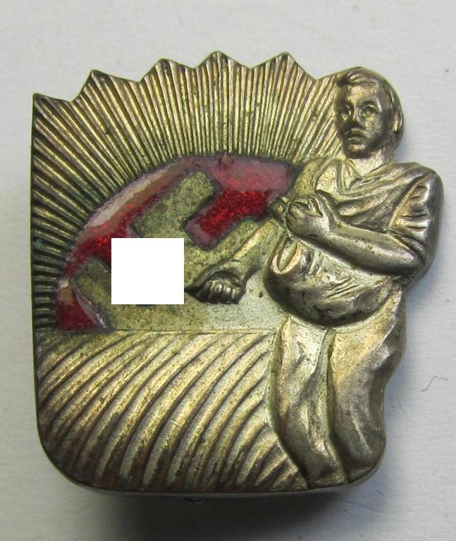 Attractive, silverish-coloured and 'Buntmetall'-based, N.S.D.A.P.-related lapel-pin (ie. 'Mitgliedsabzeichen') being a commemorative example that shows a sowing farmer-figure surrounded by an enamelled: 'Sunburst'-swastika