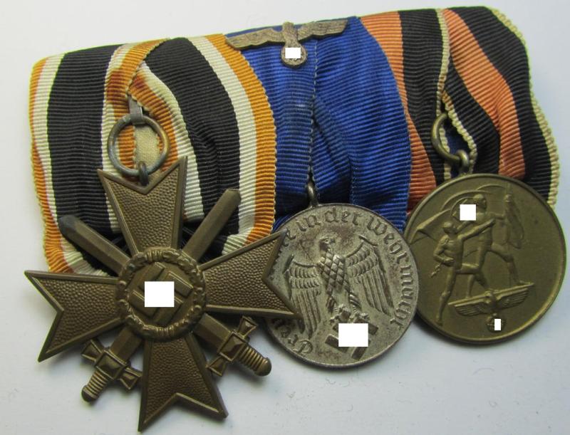 Attractive example of a three-pieced medal-bar (ie.: 'Ordenspange') resp. showing a: 'KvK 2. Klasse mit Schwertern', a: 'WH-DA 4. Stufe' (with firmly attached eagle-device) and a Czech 'Anschluss'-medal '1 Oktober 1938'