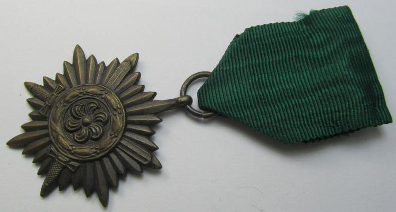 WH-related so-called: 'Tapferkeitsauszeichnung für Angehörige der Ostvölker, 3. Klasse in Bronze mit Schwerter' (being a non-maker-marked- and/or: 'Feinzink'-based example that comes mounted onto its period ribbon)