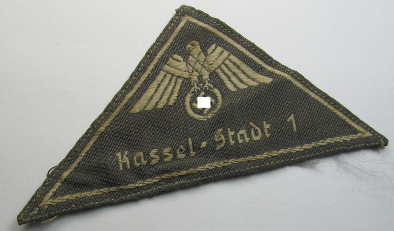 Attractive, German Red Cross (ie. 'Deutsches Rotes Kreuz' or 'DRK') greyish-coloured- and/or (typically) triangular-shaped arm-eagle entitled: 'Kassel - Stadt 1' as was executed in the neat 'BeVo'-weave pattern