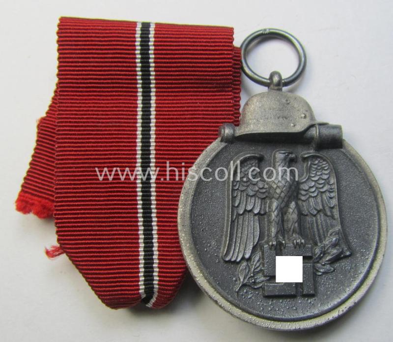 Attractive medal-set: 'Winterschlacht im Osten 1941-42' being a maker- (ie. '6.'-) marked- (and/or 'Feinzink'-based) specimen by the maker: 'Fritz Zimmermann' and that comes together with its (minimally confectioned) ribbon (ie. 'Bandabschnitt')
