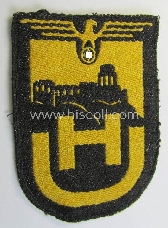 Superb - very unusual and only twice before encountered! - linnen-based- and/or: 'BeVo'-woven (smaller!) cloth-based sportshirt-patch depicting a capital: 'H' and 'U'-character as intended for usage by students of the: 'Universität Heidelberg'