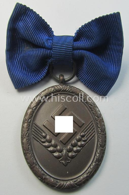 Superb example of a: 'Reichsarbeitsdienst der weiblichen Jugend' (or: RADwJ) so-called: 'Dienstauszeichnung 4. Stufe in Bronze' that comes mounted onto its period-attached ('bow-tie'-shaped!) ribbon (ie. 'Bandabschnitt')