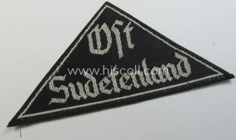 'HJ' ('Hitlerjugend') ie. 'BDM'- ('Bund Deutscher Mädel') district-triangle (ie. 'Gebietsdreieck') entitled: 'Ost Sudetenland' (being a hardly used- nor worn example that still retains its period-attached 'RzM'-etiket)
