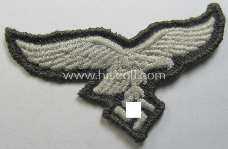 Neat, 'variant'-pattern, WH (Luftwaffe) EM- (ie. eventually NCO-) type side-cap eagle (being a 'virtually mint- ie. unissued' example as executed in typical machine-embroidered-pattern onto an unusally seen 'thin-shaped' background)