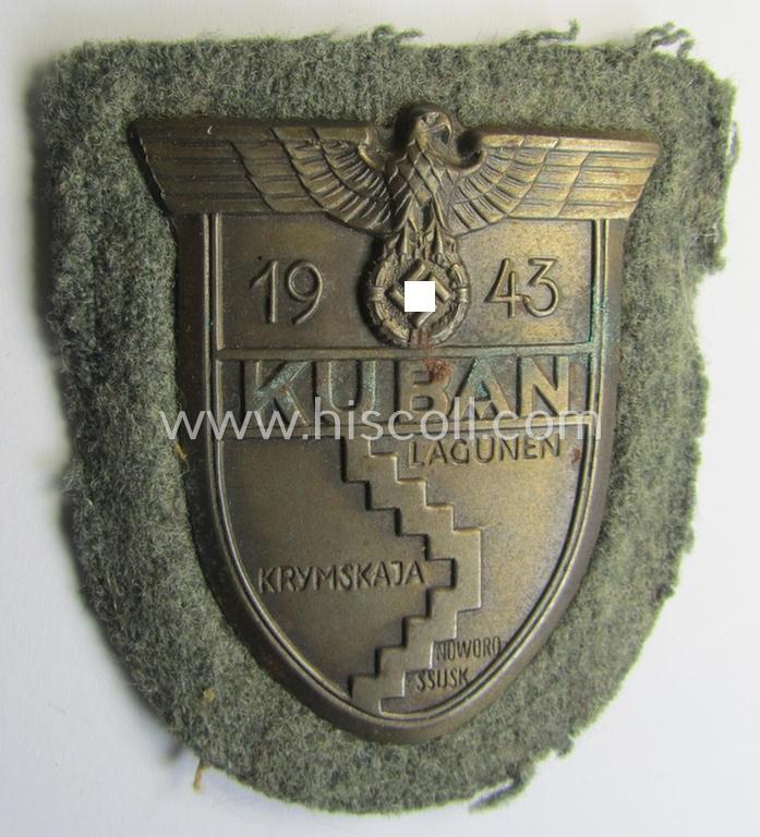 Attractive - just moderatey used and actually scarcely encountered! - WH (Heeres ie. Waffen-SS) 'Kuban'-campaign-shield that comes mounted onto its original field-grey-coloured- and/or woolen-based 'backing'