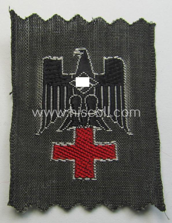 Neat - and actually scarcely encountered! - example of a German Red Cross ('DRK' or: 'Deutsches Rotes Kreuz') side-cap eagle to be worn on the specic, greyish-blue-coloured DRK side-caps (ie. 'Schiffchen')