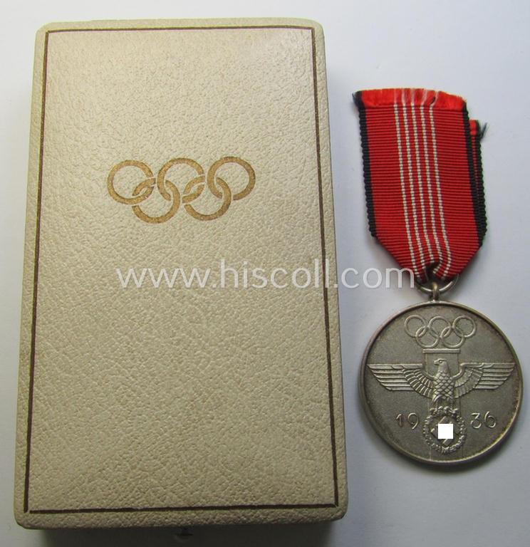 Superb, 'Deutsche Olympia-Erinnerungsmedaille 1936' being a non-maker-marked example that comes mounted onto its original ribbon (ie. 'Bandabschnitt') and that comes stored in its typical, beige-white-coloured etui as issued and stored for decades