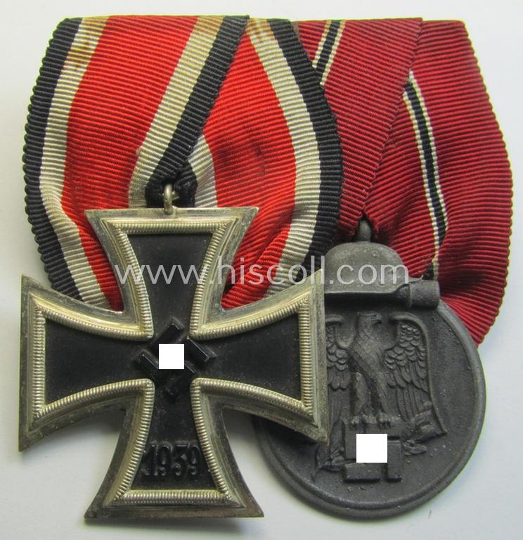 Superb, two-pieced medal-bar (ie. 'Ordenspange') showing resp. an: 'Eisernes Kreuz II. Kl.' and a: 'Medaille Winterschlacht im Osten 1941-42' that both come period-mounted as a: 'Doppelspange'