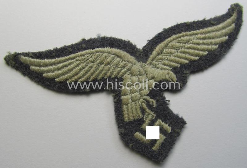 WH (Luftwaffe) enlisted-mens'- (ie NCO-) pattern, machine-embroidered breast-eagle (showing a 'down-tailed'-eagle and being an early- ie. pre-war-period example) that comes in a moderately used- ie. once tunic-attached, condition