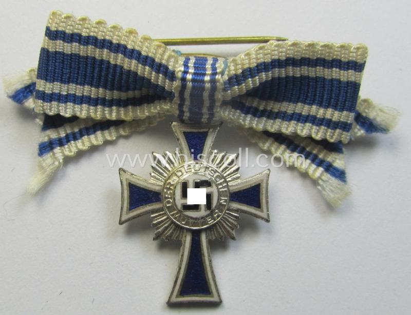 Miniature of an: 'Ehrenkreuz der deutschen Mutter - zweite Stufe' (or: silver-class mothers'-cross) being a neatly maker- (ie. 'L/60'-) marked example that comes in an overall nice- (albeit moderately worn- ie. used-), condition