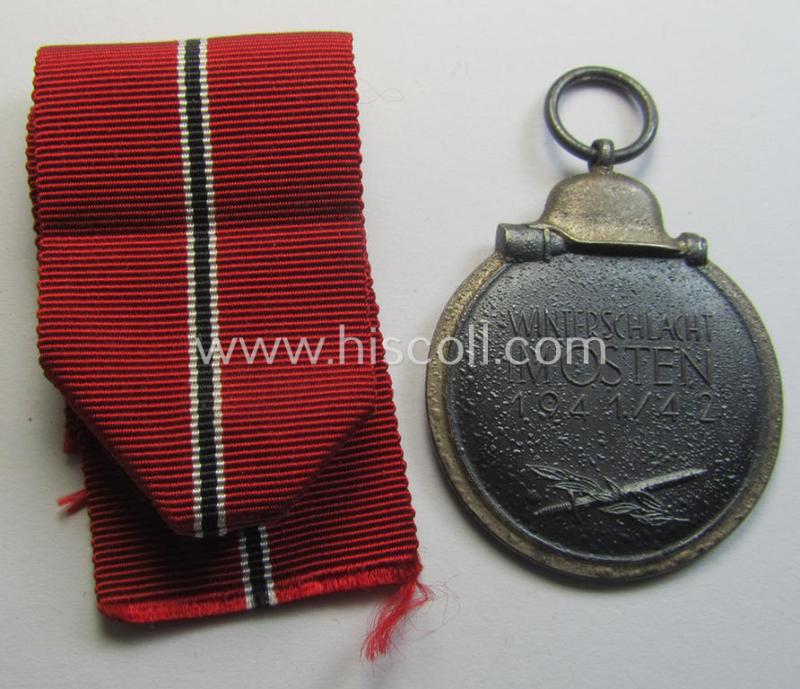 Attractive medal-set: 'Winterschlacht im Osten 1941-42' being a maker- (ie. '14'-) marked- (and/or 'Feinzink'-based) specimen by the maker: 'L.Chr. Lauer' and that comes together with its (minimally confectioned) ribbon (ie. 'Bandabschnitt')