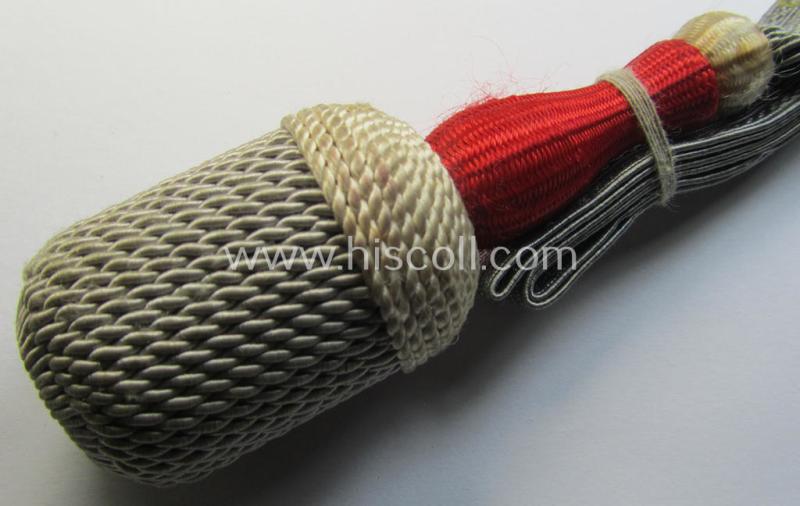 Attractive, white-, red- and red-coloured EM- (ie. NCO-) type side-arm knot (ie. 'Portepee' ie.: 'Troddel') as was used for the various WH-bayonets and that comes in an overall very nice- (ie. 'virtually mint- ie. unissued'-), condition