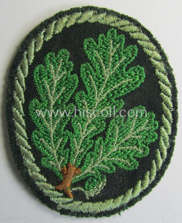 Attractive example of a WH (Heeres) so-called: 'Jäger'-armbadge being a neatly machine-embroidered- and/or multi-coloured version as was executed on darker-green-coloured wool
