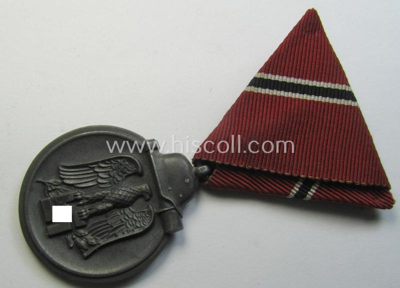 Medal-set: 'Medaille Winterschlacht im Osten 1941-42' (or: Eastern Front medal) being a non-maker-marked specimen that comes mounted onto its original 'pre-confectioned' and/or: typical 'Austrian'-styled ribbon (ie. 'Bandabschnitt')