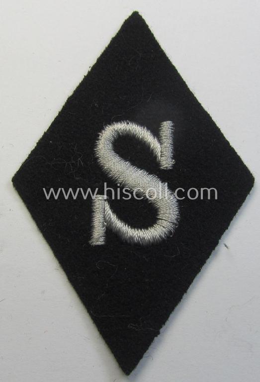 Attractive - and rarely found! - Waffen-SS-pattern, machine-embroidered and black-coloured sleeve-insignia (ie. 'Ärmelraute') depicting a captital: 'S'-character as was used to signify the function of: 'Schirrmeister' within the: 'Waffen-SS'