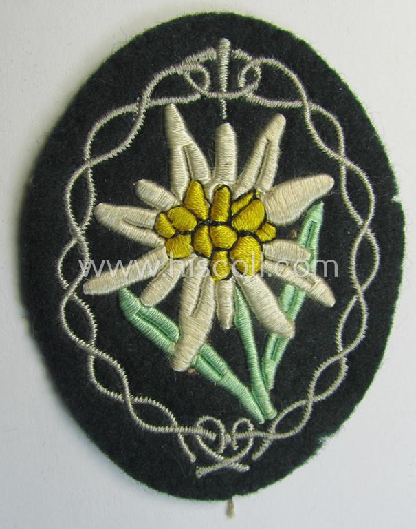Attractive - and truly worn! - WH (Heeres) EM- (ie. NCO-) type 'Edelweiss'-armpatch being a machine-embroidered example as was executed on darker-green wool as was intended for usage by the: 'Gebirgsjäger-Truppen' throughout the war