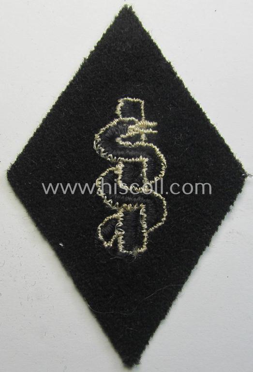 Waffen-SS-pattern, machine-embroidered and/or black- and white-coloured sleeve-insignia (ie. 'Ärmelraute') depicting a so-called: 'Aesculapus'-sign as was used and intended to signify membership within the 'SS-Sanitätsdienst'