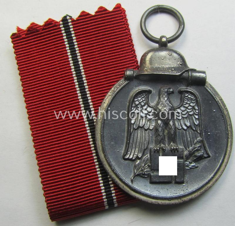 Attractive medal-set: 'Winterschlacht im Osten 1941-42' being a maker- (ie. '65'-) marked- (and/or 'Feinzink'-based) specimen by the maker: 'Klein & Quenzer' and that comes together with its (non-confectioned) ribbon (ie. 'Bandabschnitt')