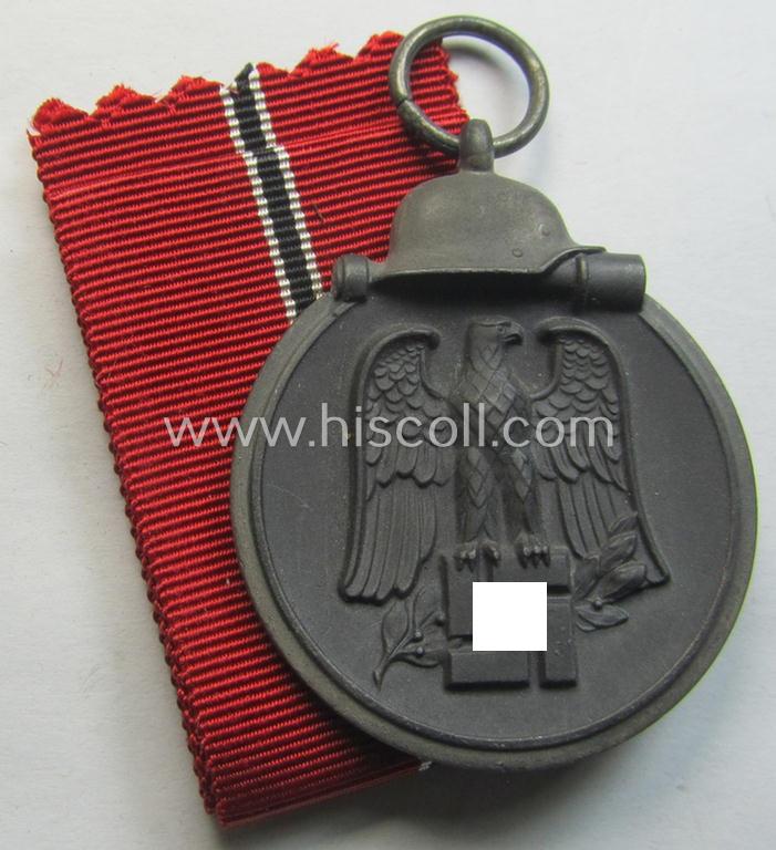 Attractive medal-set: 'Winterschlacht im Osten 1941-42' being a maker- (ie. '110'-) marked- (and/or 'Feinzink'-based) specimen by the maker: 'Otto Zappe' and that comes together with its (non-confectioned) ribbon (ie. 'Bandabschnitt')