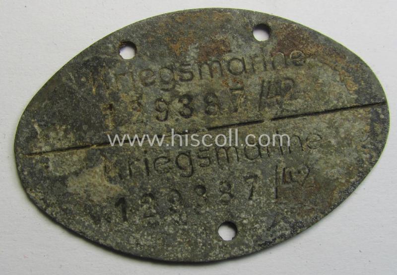 Mid-war- (albeit 'standard-issue'-) pattern, WH (Kriegsmarine) typical zinc- (ie. 'Feinzink'-) based- and greyish-silver-toned ID-disc (ie. 'Erkennungsmarke') bearing the engraved coded numeral (ie. text) that reads: 'Kriegsmarine 129387/42'