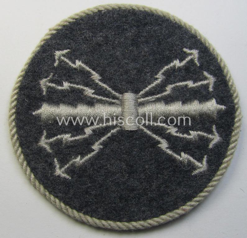 Attractive - and hardly used! - example of a WH (Luftwaffe) machine-embroidered, trade- ie. special-career-patch (ie. 'Tätigkeitsabzeichen') having a silverish-grey-toned 'Kordel' attached as was intended for: 'LW-Funk-Unteroffiziere'