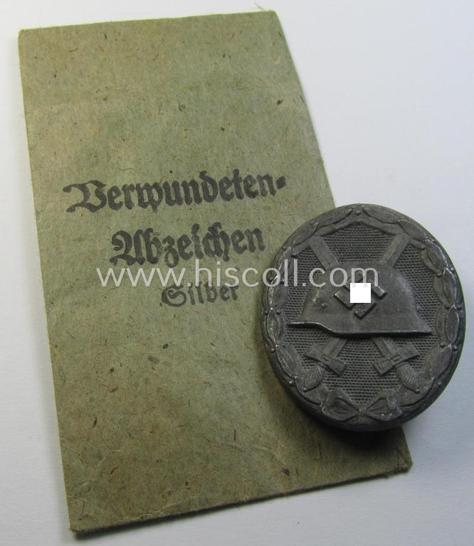 Attractive, silver-class wound-badge (or: 'Verwundeten-Abzeichen in Siber') being a non-maker-marked example that comes stored in its original, carton-based pouch as was produced by the maker (ie. 'Hersteller'): 'Steinhauer & Lück'