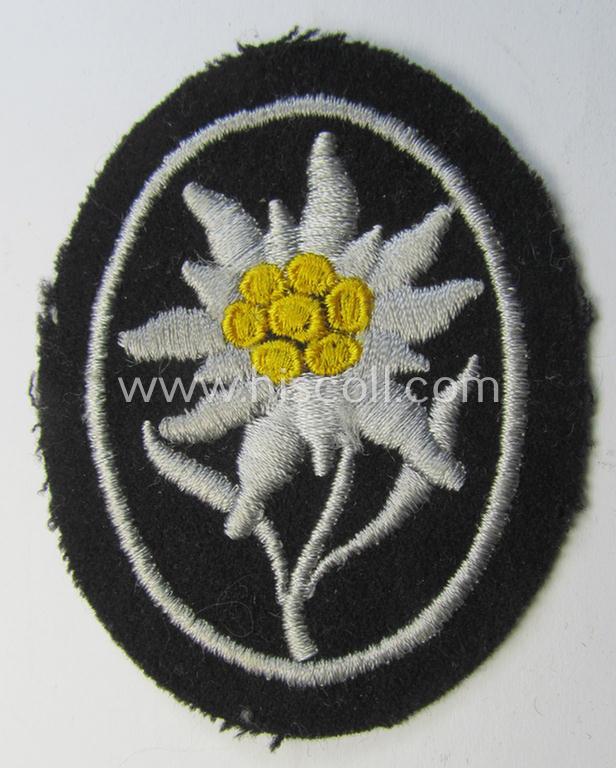 Waffen-SS-pattern, black-coloured sleeve-insignia (ie. 'Ärmelabzeichen') depicting an: 'Edelweiss'-flower, as used by the various 'Gebirgsjäger'- (ie. mountain-troops-) related divisional-staff